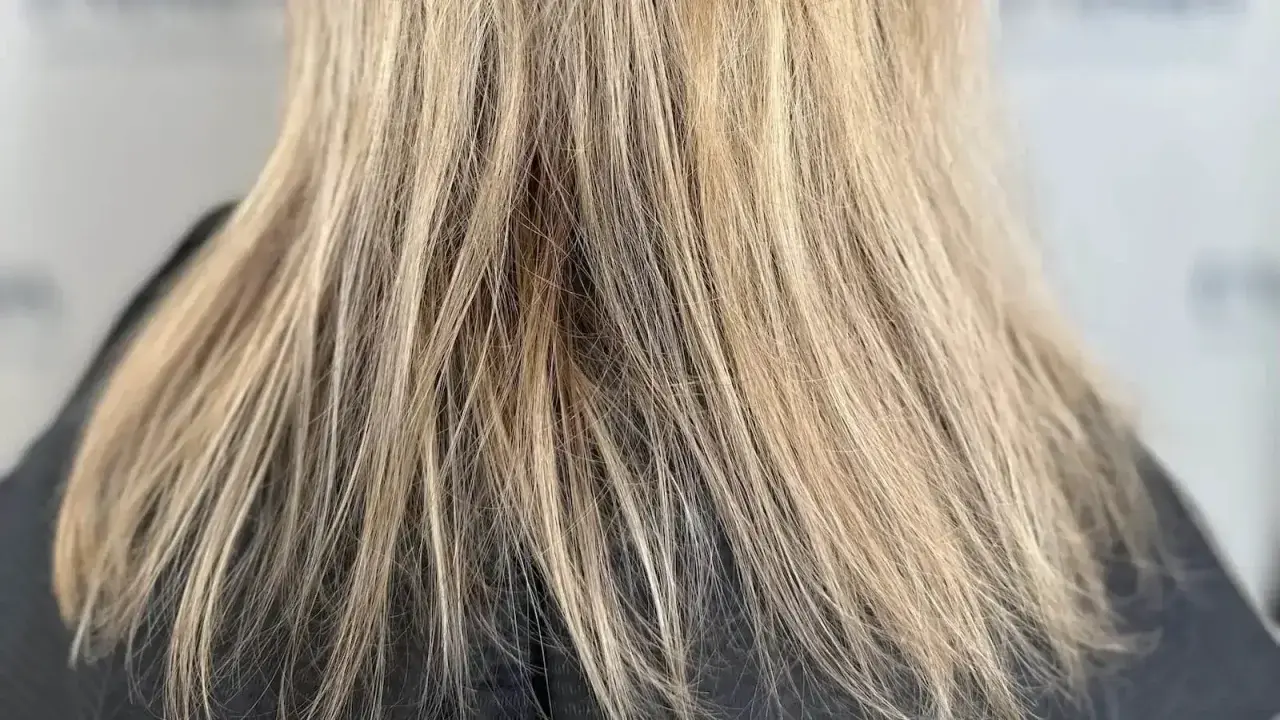 Glänzendes, blondiertes Haar, das nach der richtigen Pflege strahlt.