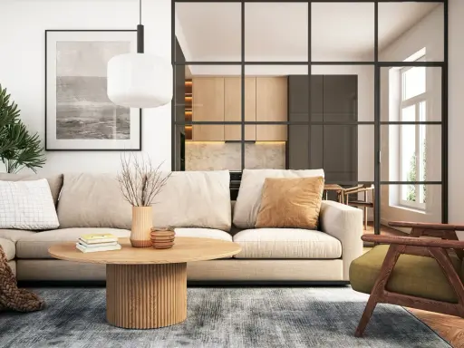 Modernes wohnzimmer einrichten: Beige Couch, Holztisch, grüner Sessel und eine offene Küche hinter Glas.