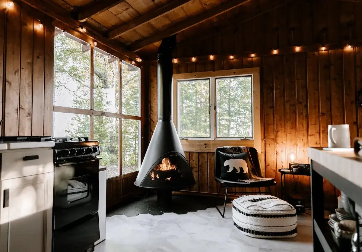 Gemütliches wohnzimmer einrichten modern mit Kamin, Sitzgelegenheit und Blick ins Grüne.